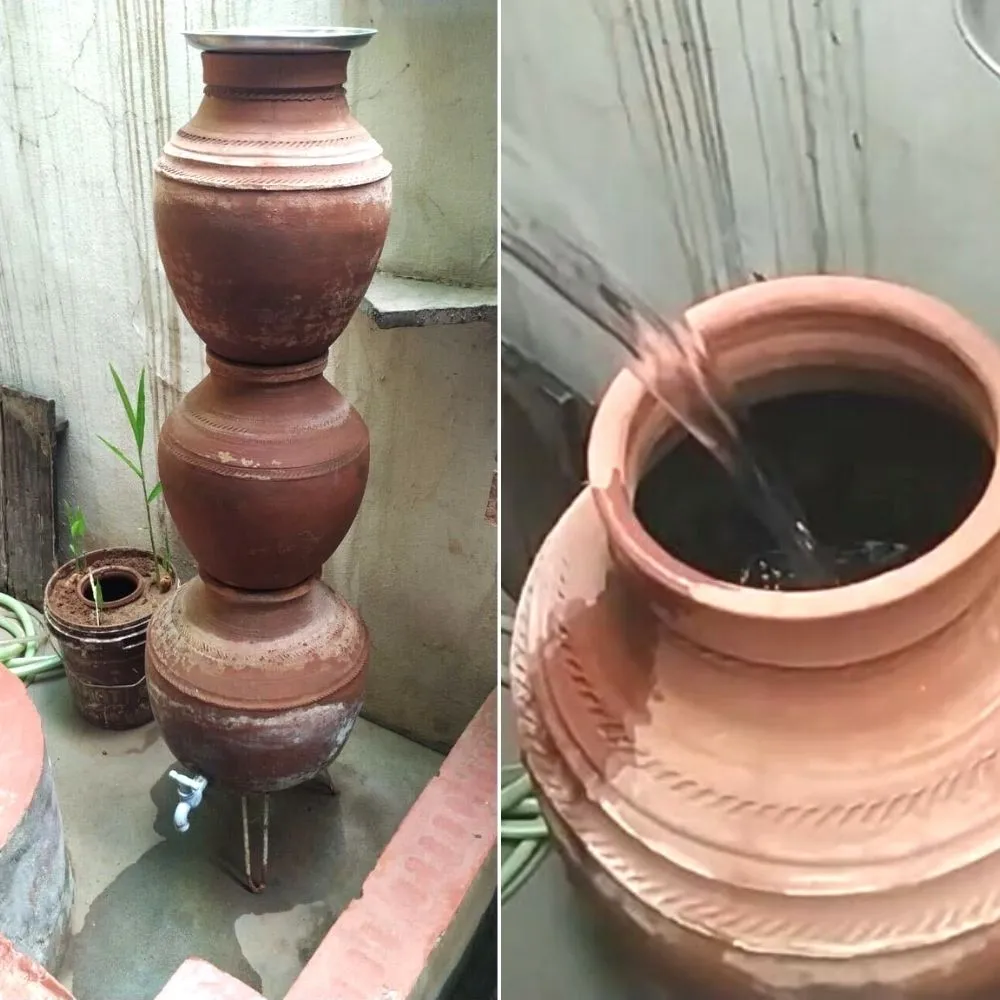 Ein Wasserfilter aus Erde mit drei übereinander gestapelten Töpfen und Wasserfluss.